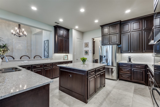 kitchen featuring tasteful backsplash, sink, and dark brown cabinetry