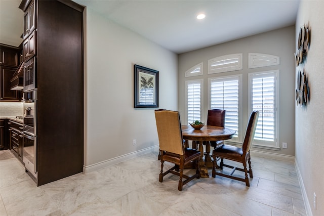 dining space with light tile patterned flooring and plenty of natural light