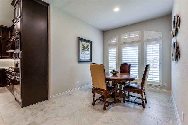 dining room featuring recessed lighting and baseboards