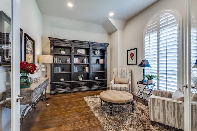 living area featuring baseboards, wood finished floors, and recessed lighting