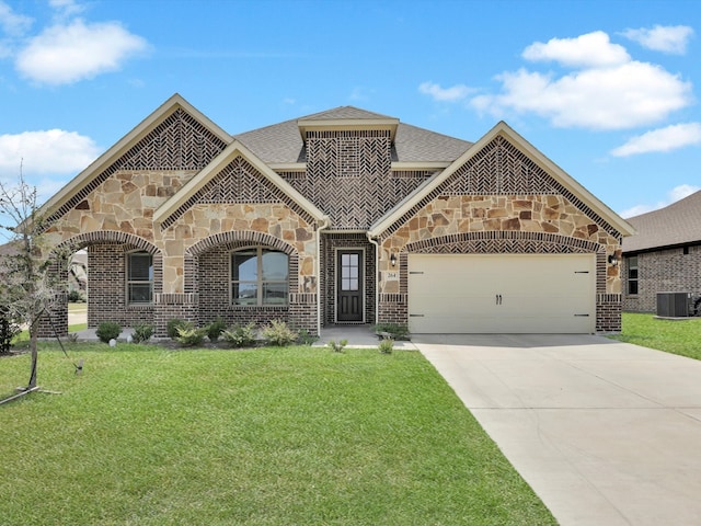 mediterranean / spanish-style house featuring a garage, cooling unit, and a front yard