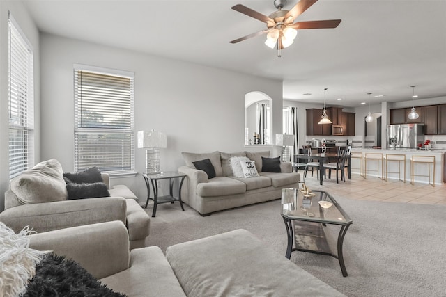 living room featuring ceiling fan and light colored carpet