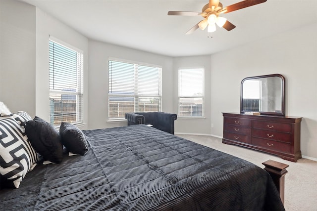 bedroom with ceiling fan and light carpet