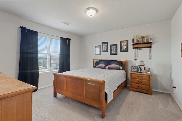 bedroom featuring light carpet