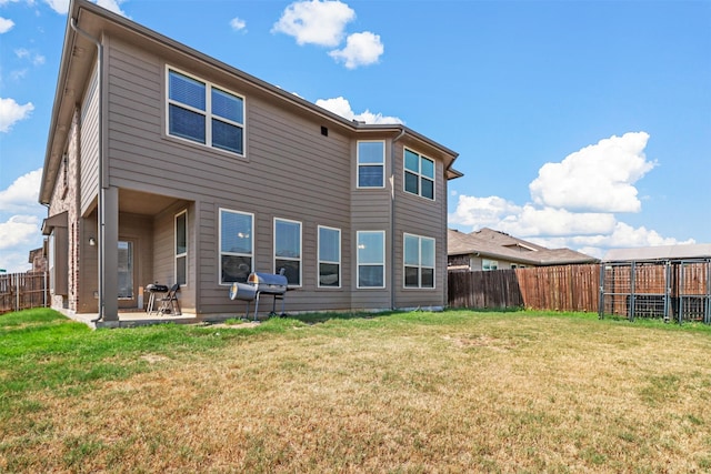 rear view of property featuring a patio and a lawn