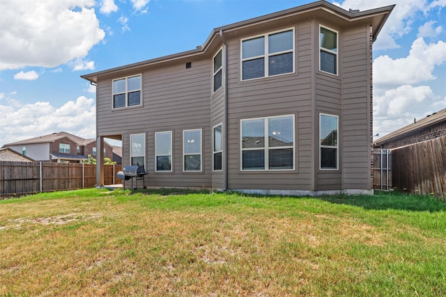 rear view of property featuring a yard