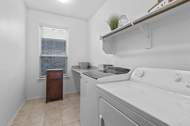 washroom featuring washing machine and clothes dryer and light tile patterned flooring