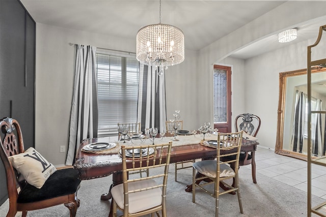 tiled dining room with an inviting chandelier and a wealth of natural light