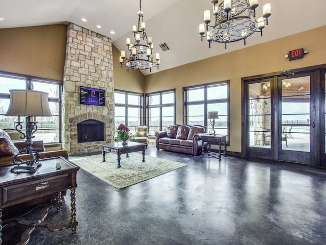 living room with high vaulted ceiling, a stone fireplace, and an inviting chandelier