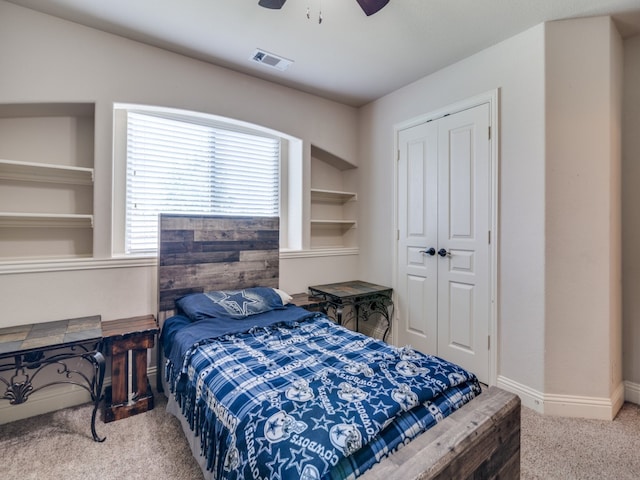 bedroom featuring ceiling fan, a closet, and light colored carpet