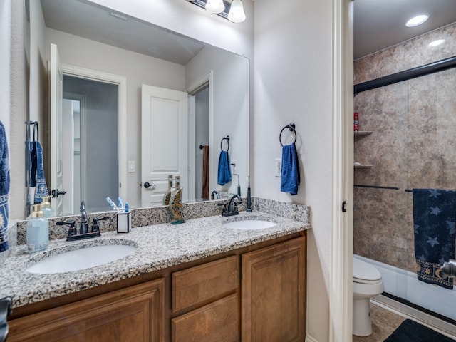 full bathroom with dual vanity, tiled shower / bath combo, toilet, and tile patterned flooring