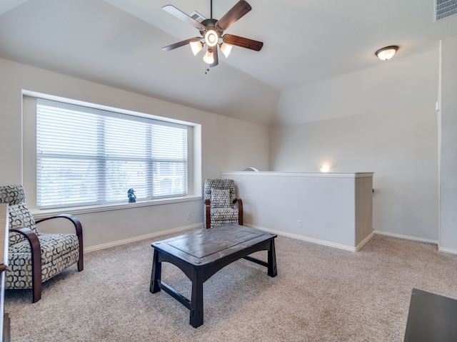 interior space with ceiling fan, vaulted ceiling, and light carpet