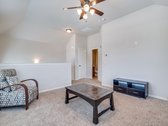 carpeted living room with ceiling fan and lofted ceiling