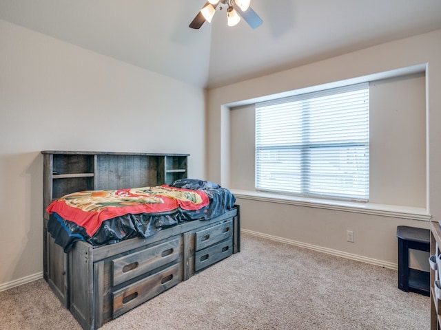 carpeted bedroom with ceiling fan and lofted ceiling