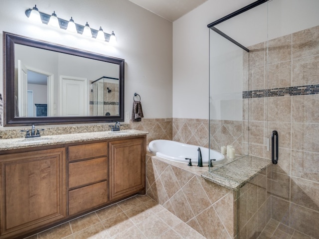 bathroom featuring dual vanity, tile patterned floors, and separate shower and tub