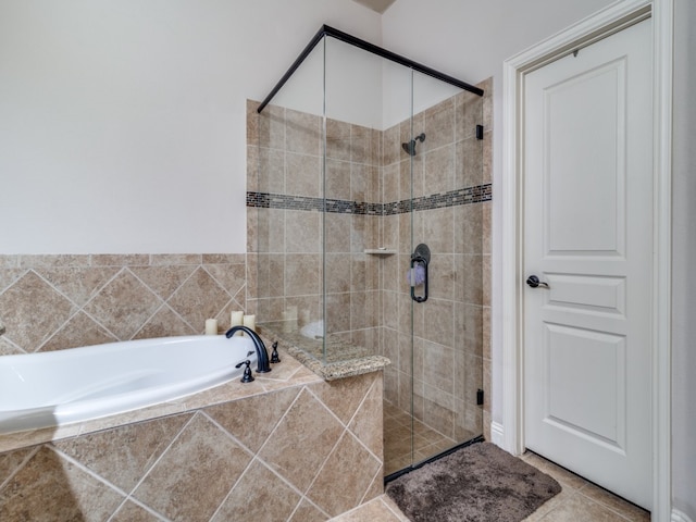 bathroom with shower with separate bathtub and tile patterned flooring