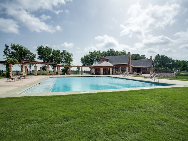 view of pool with a yard and a gazebo