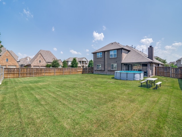 view of yard with a fenced in pool