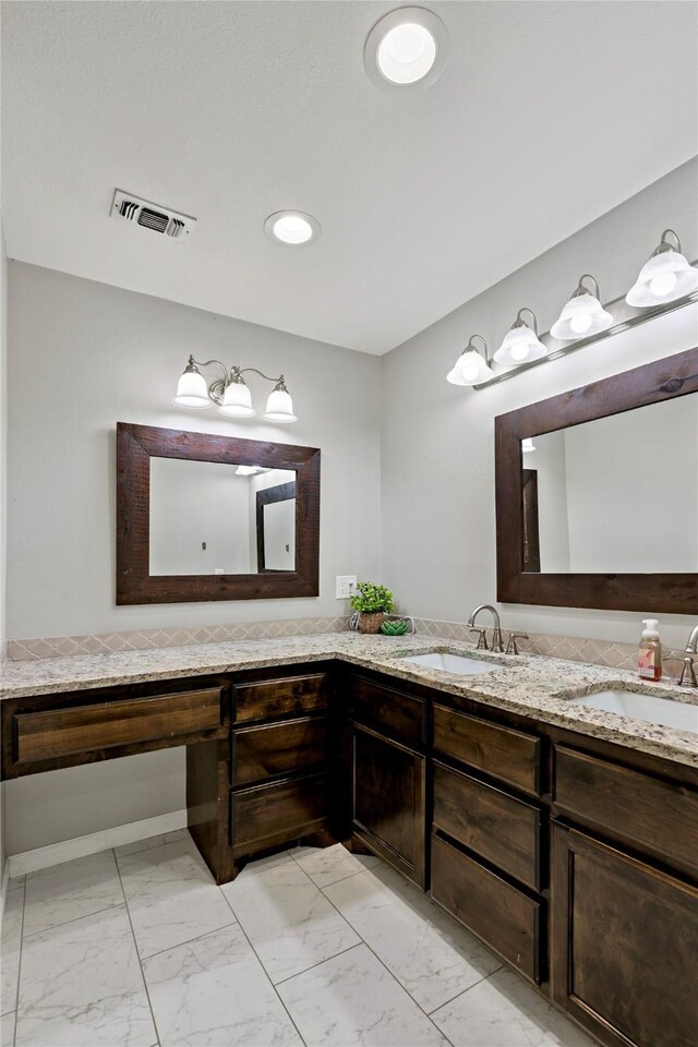 bathroom featuring tile patterned floors and double vanity