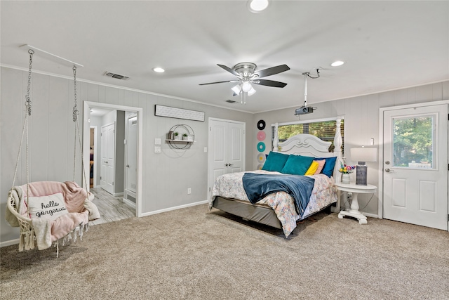 carpeted bedroom with ceiling fan and crown molding