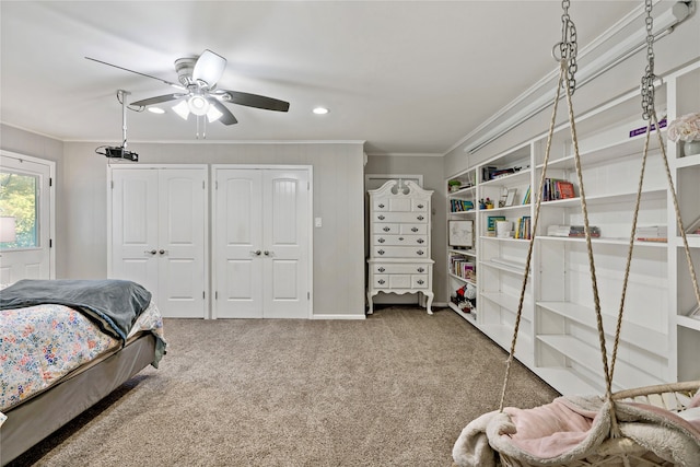 carpeted bedroom with ceiling fan and ornamental molding