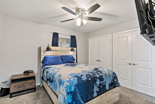 carpeted bedroom featuring two closets and ceiling fan