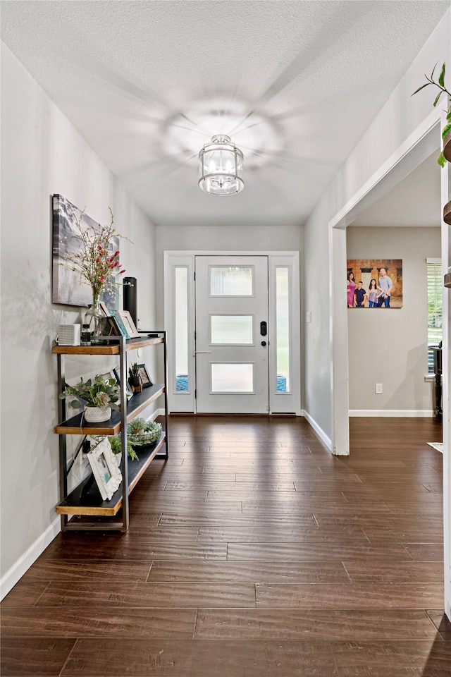 foyer featuring a textured ceiling and hardwood / wood-style flooring