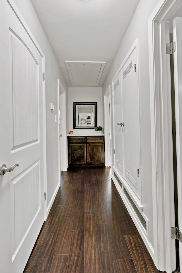 corridor with dark hardwood / wood-style floors