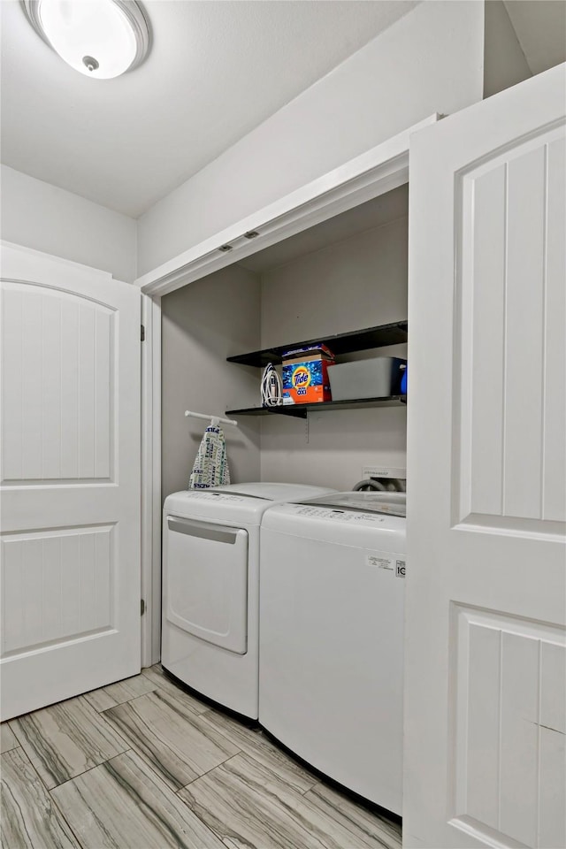 clothes washing area featuring independent washer and dryer