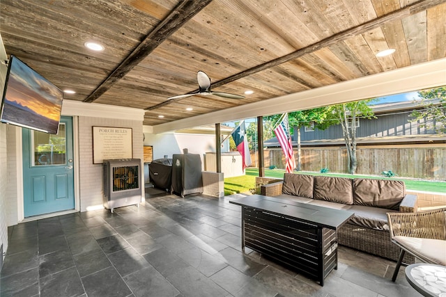 view of patio / terrace featuring ceiling fan, an outdoor living space, and a storage shed