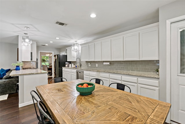 dining room featuring sink and dark wood-type flooring