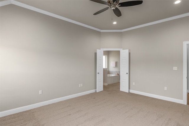 carpeted empty room featuring ornamental molding, ceiling fan, and a high ceiling