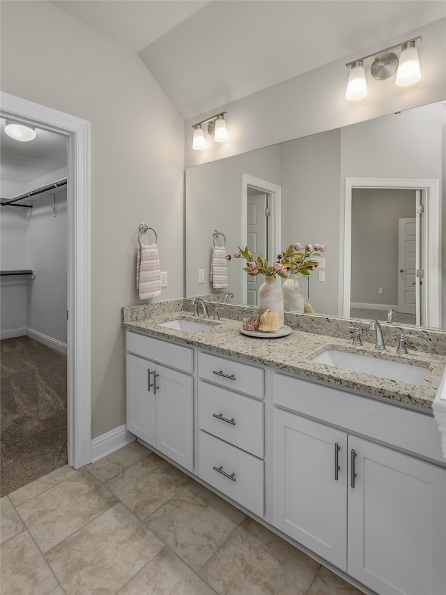 bathroom with double vanity and tile patterned flooring