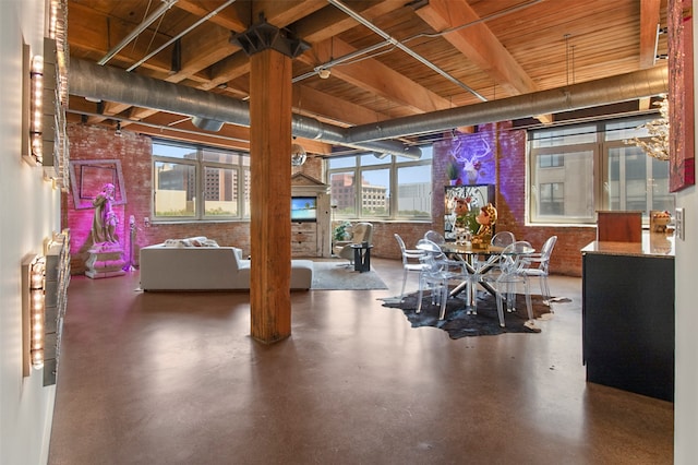 interior space featuring brick wall and plenty of natural light