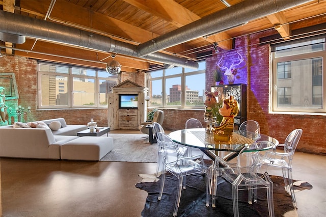 dining room with brick wall, concrete floors, and wood ceiling