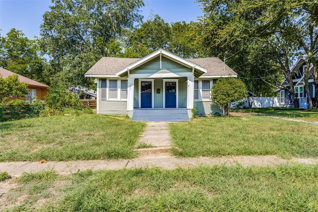 bungalow-style house featuring a front yard