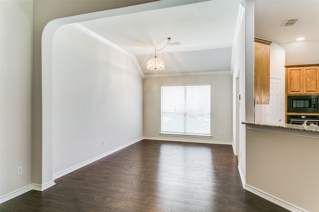 interior space featuring vaulted ceiling, dark wood-type flooring, ornamental molding, and an inviting chandelier