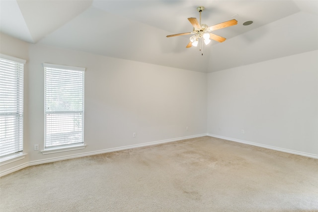 empty room with lofted ceiling, light carpet, and ceiling fan