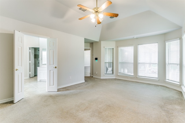 carpeted empty room featuring ceiling fan and vaulted ceiling