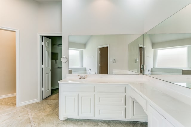 bathroom featuring plenty of natural light, vanity, and tile patterned flooring