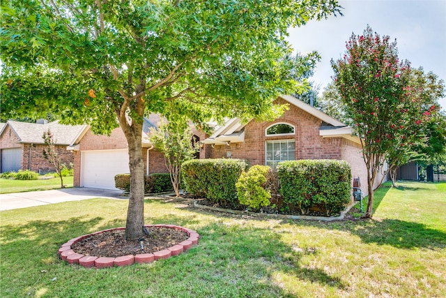 view of front of property featuring a garage and a front lawn