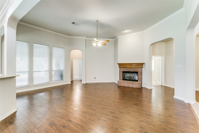 unfurnished living room with ceiling fan, a fireplace, hardwood / wood-style flooring, and ornamental molding