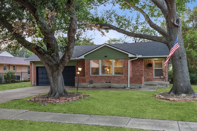 ranch-style house featuring a front yard and a garage