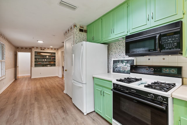 kitchen with light hardwood / wood-style floors, decorative backsplash, white appliances, and green cabinets