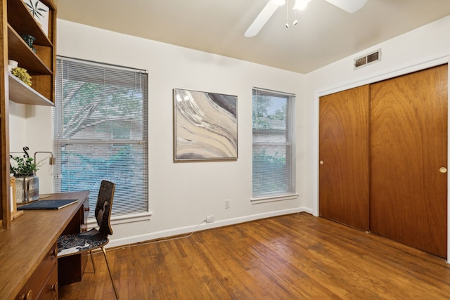 office space with ceiling fan, plenty of natural light, and dark wood-type flooring