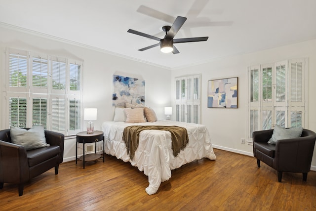 bedroom with ceiling fan, hardwood / wood-style flooring, and crown molding