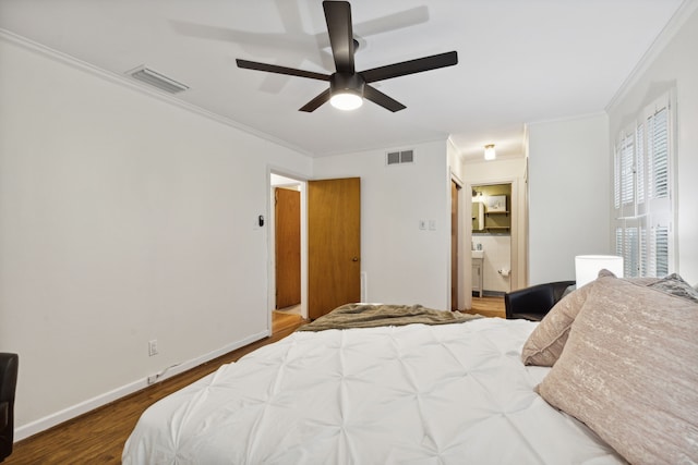 bedroom featuring ceiling fan, crown molding, hardwood / wood-style flooring, and ensuite bathroom