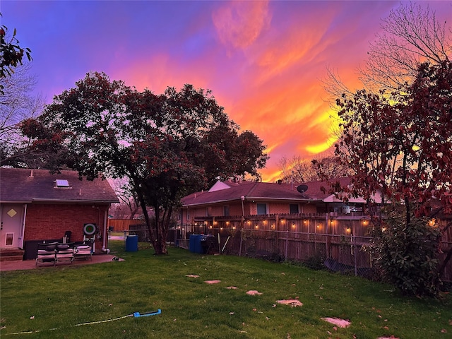 yard at dusk with a patio