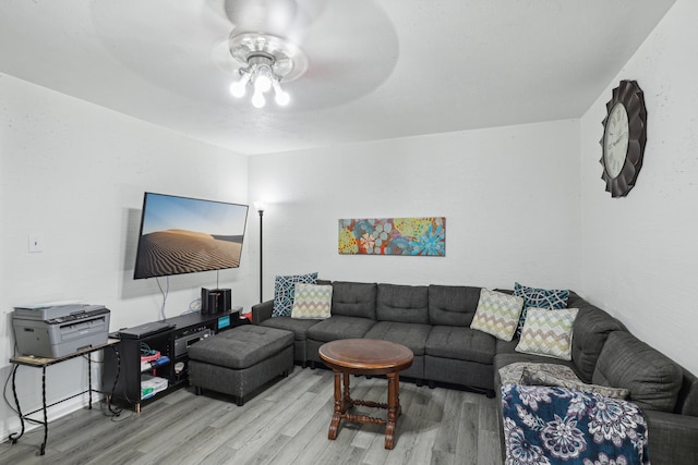 living room with ceiling fan and light wood-type flooring