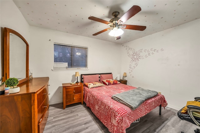 bedroom with light hardwood / wood-style flooring and ceiling fan